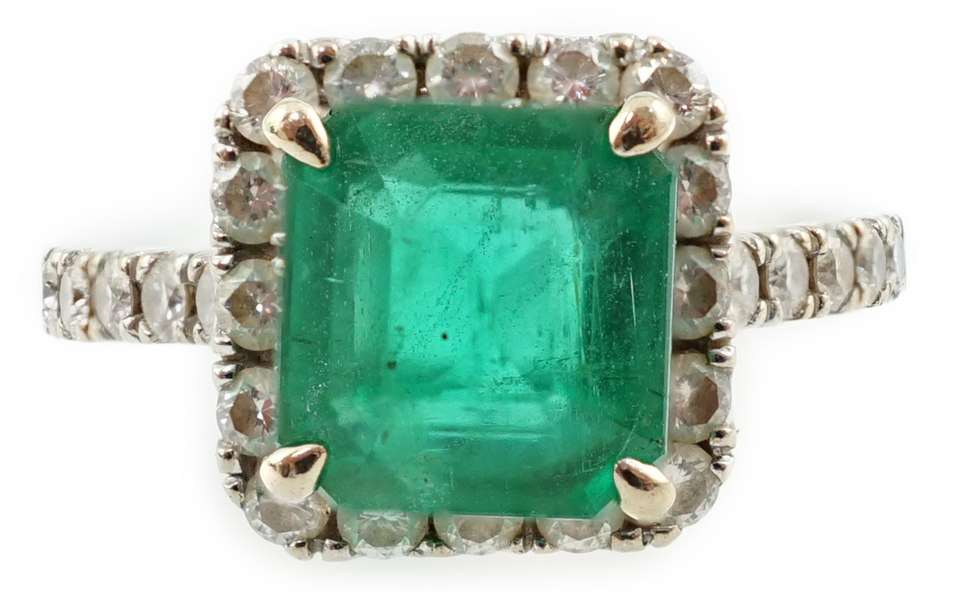 A modern 18k white gold, emerald and diamond set square cluster ring